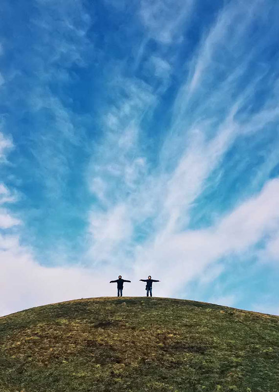 two people on top of a hill